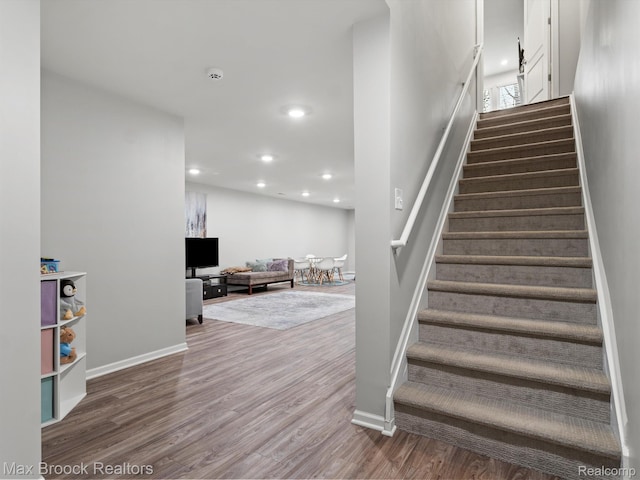 764 Hummingbird Dr, Rochester, MI 48307 - stairs with wood finished floors, baseboards, and recessed lighting