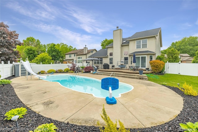 18615 Andrew Ln, New Boston, MI 48164 - view of swimming pool with a water slide, a patio, and a gate