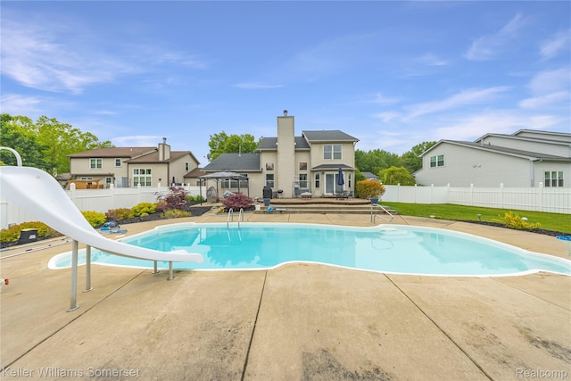 18615 Andrew Ln, New Boston, MI 48164 - view of pool with a water slide, a fenced backyard, a patio, and a deck