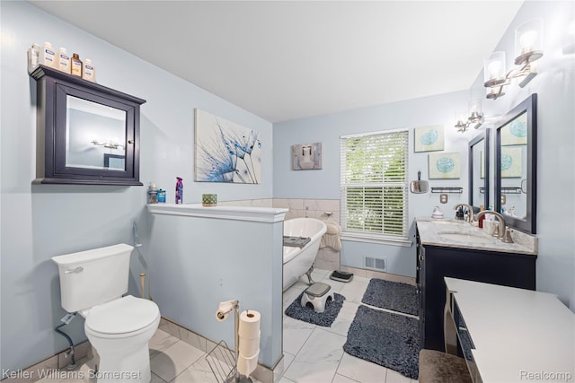 18615 Andrew Ln, New Boston, MI 48164 - full bath with a freestanding tub, marble finish floors, vanity, and toilet
