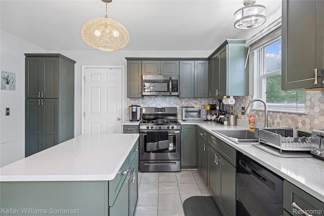 18615 Andrew Ln, New Boston, MI 48164 - kitchen with stainless steel appliances, a sink, a chandelier, decorative backsplash, and light countertops