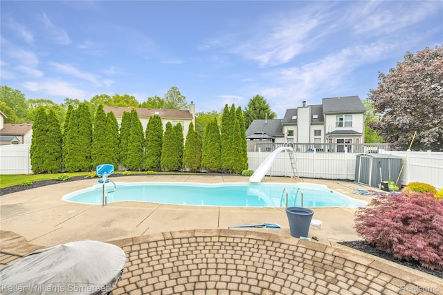 18615 Andrew Ln, New Boston, MI 48164 - view of pool with a water slide, a fenced backyard, and a patio area