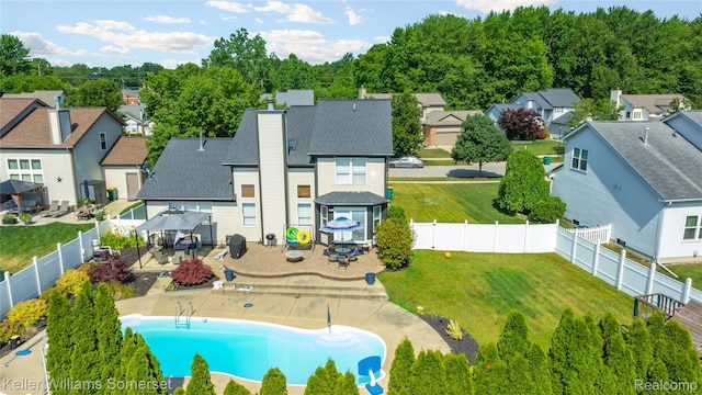 18615 Andrew Ln, New Boston, MI 48164 - rear view of house with a residential view, a fenced backyard, and outdoor dining area