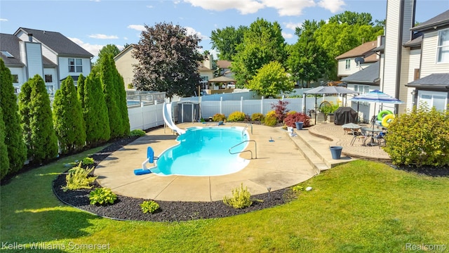 18615 Andrew Ln, New Boston, MI 48164 - view of pool with a water slide, a fenced backyard, a patio area, and a residential view
