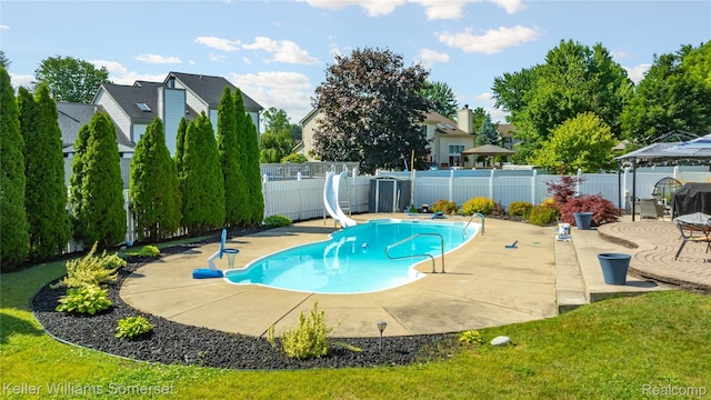 18615 Andrew Ln, New Boston, MI 48164 - view of pool featuring a water slide, a fenced backyard, a patio, and a gazebo