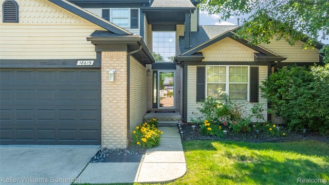 18615 Andrew Ln, New Boston, MI 48164 - view of front of home with a front lawn, roof with shingles, driveway, and an attached garage