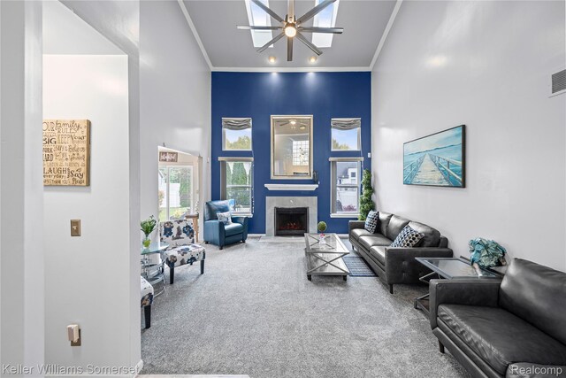 18615 Andrew Ln, New Boston, MI 48164 - living room with carpet flooring, ceiling fan, a high ceiling, ornamental molding, and a premium fireplace