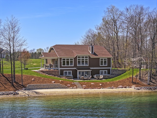 333 S W Silver Lake Rd, Michigan, MI 49685 - back of property featuring a water view and a patio area