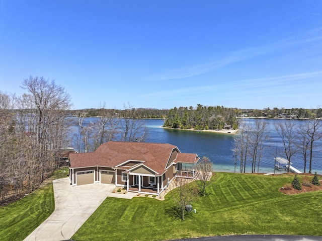 333 S W Silver Lake Rd, Michigan, MI 49685 - view of front of house with a garage, a front yard, a water view, and concrete driveway