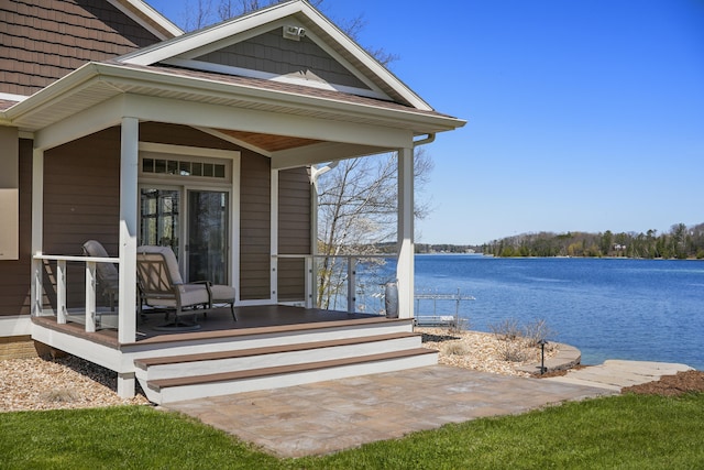 333 S W Silver Lake Rd, Michigan, MI 49685 - view of exterior entry with a water view and covered porch
