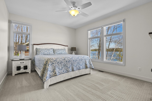 333 S W Silver Lake Rd, Michigan, MI 49685 - bedroom with baseboards, carpet, and ceiling fan