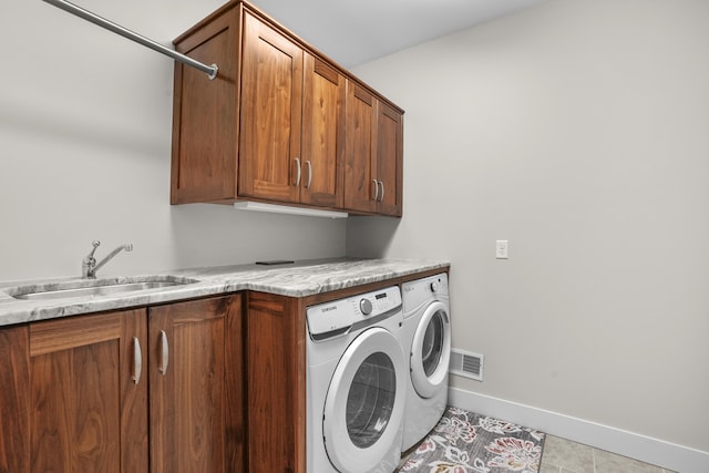 333 S W Silver Lake Rd, Michigan, MI 49685 - laundry room featuring washer and dryer, cabinet space, baseboards, and light tile patterned flooring