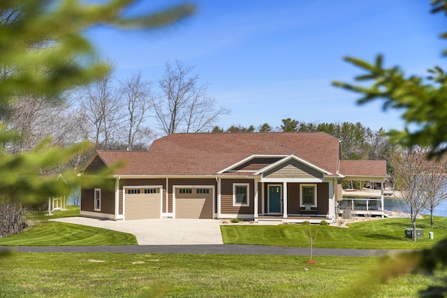 333 S W Silver Lake Rd, Michigan, MI 49685 - view of front of home with an attached garage, a front yard, driveway, and covered porch