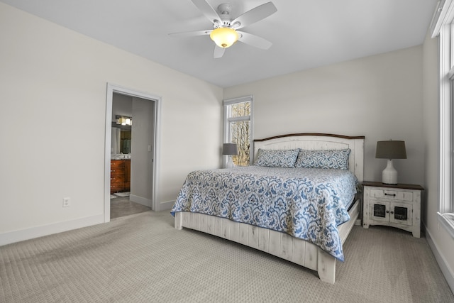 333 S W Silver Lake Rd, Michigan, MI 49685 - carpeted bedroom featuring baseboards, ceiling fan, and ensuite bath