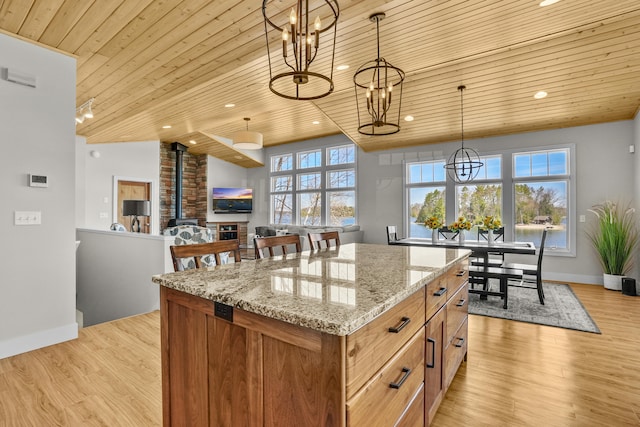 333 S W Silver Lake Rd, Michigan, MI 49685 - kitchen featuring wooden ceiling, a chandelier, hanging light fixtures, a center island, and baseboards