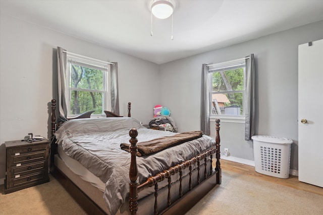 5245 Puetz Rd, Stevensville, MI 49127 - bedroom with multiple windows, light wood-style floors, and ceiling fan
