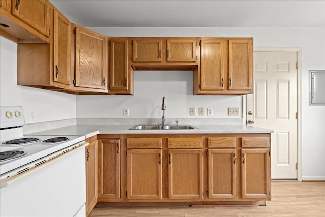 4020 Red Wing Dr, Flint, MI 48532 - kitchen featuring white range with electric cooktop, a sink, light countertops, and light wood-type flooring