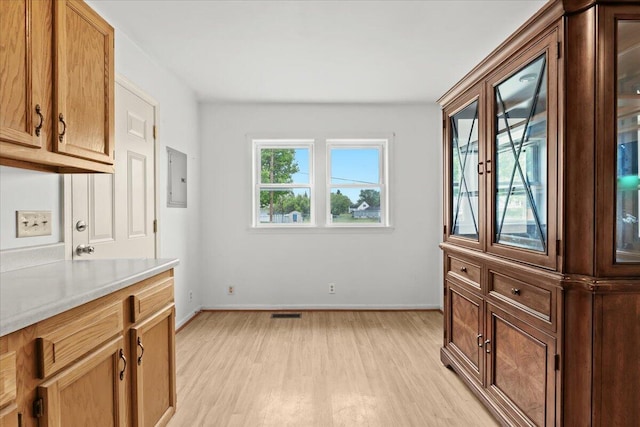 4020 Red Wing Dr, Flint, MI 48532 - unfurnished dining area with light wood-style floors, baseboards, and electric panel