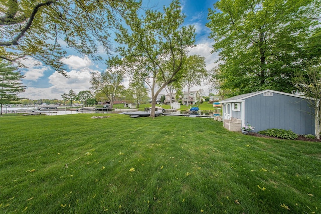 3063 Lansdowne Rd, Waterford, MI 48329 - view of green lawn featuring a water view and an outbuilding