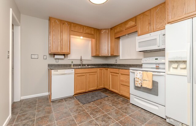 3063 Lansdowne Rd, Waterford, MI 48329 - kitchen featuring white appliances, a sink, dark countertops, baseboards, and light brown cabinets