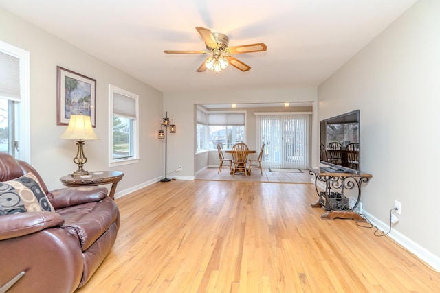 3063 Lansdowne Rd, Waterford, MI 48329 - living room with a ceiling fan, light wood-style floors, and baseboards