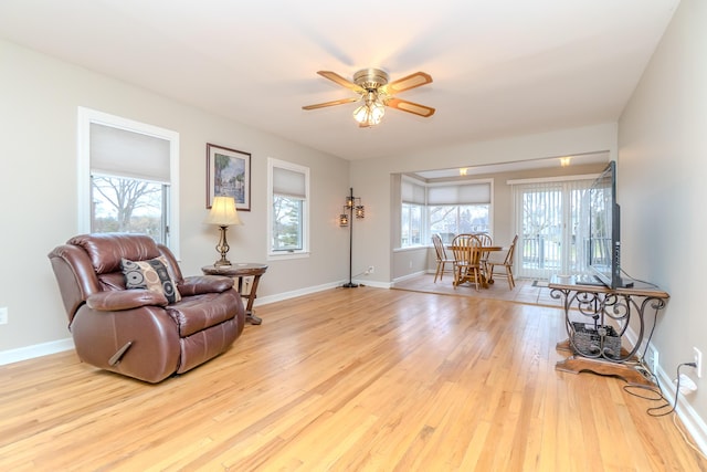 3063 Lansdowne Rd, Waterford, MI 48329 - living room with wood finished floors, ceiling fan, and baseboards