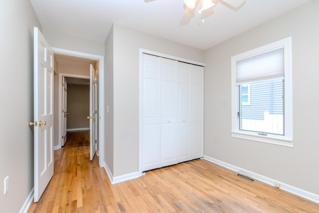 3063 Lansdowne Rd, Waterford, MI 48329 - unfurnished bedroom featuring light wood finished floors, baseboards, a closet, and a ceiling fan