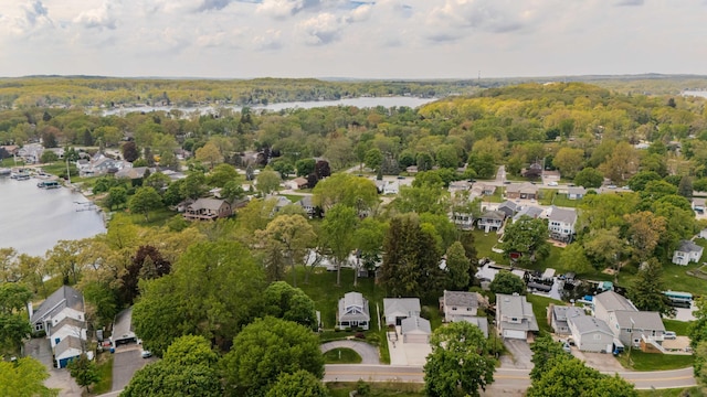 3063 Lansdowne Rd, Waterford, MI 48329 - aerial overview of property's location with a large body of water, nearby suburban area, and a heavily wooded area