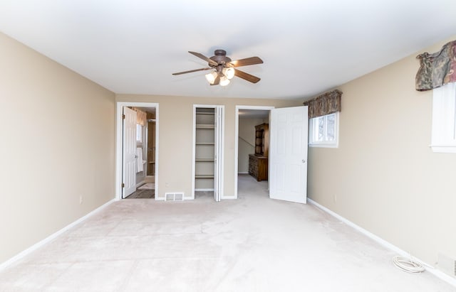 3063 Lansdowne Rd, Waterford, MI 48329 - unfurnished bedroom featuring a spacious closet, light carpet, baseboards, and ensuite bathroom