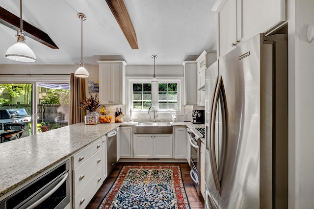 283 Wiley Rd, Douglas, MI 49406 - kitchen with appliances with stainless steel finishes, a sink, healthy amount of natural light, white cabinetry, and beamed ceiling