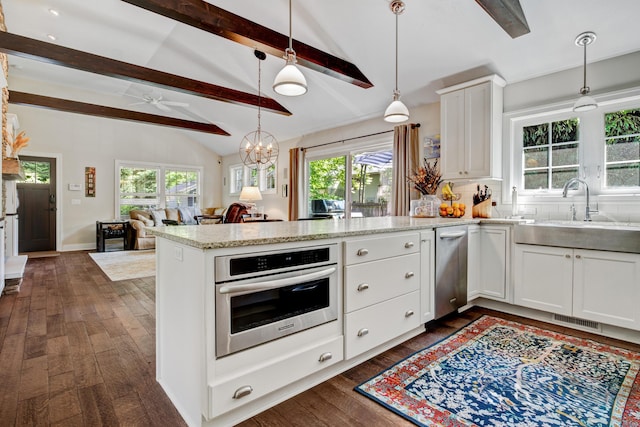 283 Wiley Rd, Douglas, MI 49406 - kitchen featuring stainless steel appliances, a peninsula, dark wood-style floors, and ceiling fan