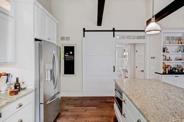 283 Wiley Rd, Douglas, MI 49406 - kitchen with stainless steel appliances, dark wood finished floors, white cabinets, a barn door, and light stone countertops