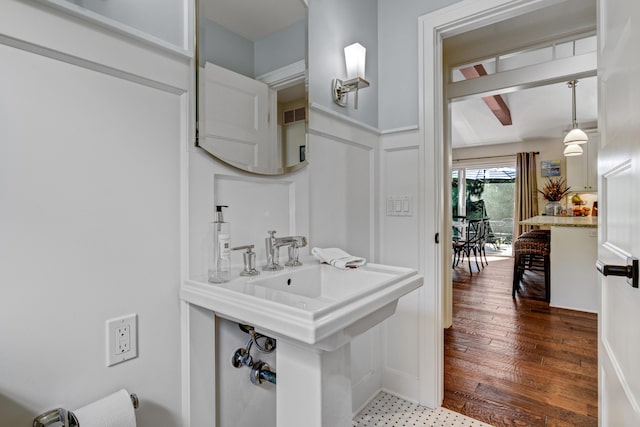 283 Wiley Rd, Douglas, MI 49406 - bathroom featuring a decorative wall, wainscoting, and wood finished floors