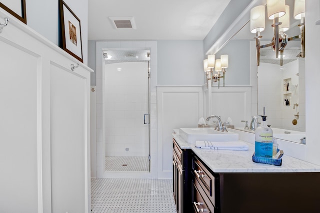 283 Wiley Rd, Douglas, MI 49406 - bathroom featuring tiled shower, vanity, and wainscoting