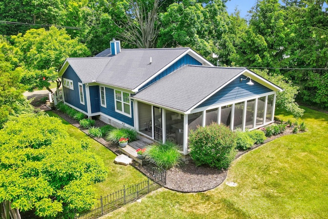 283 Wiley Rd, Douglas, MI 49406 - rear view of house featuring a sunroom, a shingled roof, and a chimney
