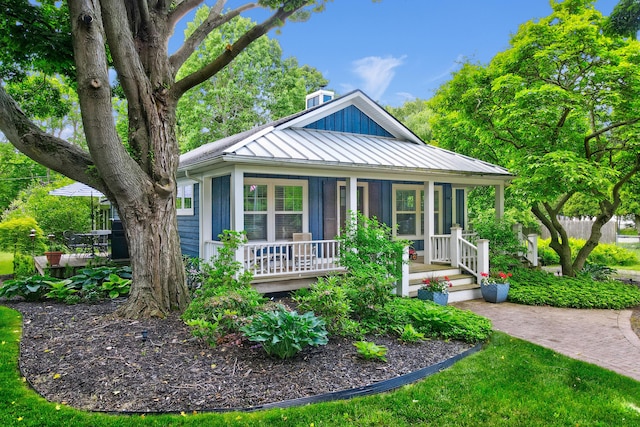 283 Wiley Rd, Douglas, MI 49406 - bungalow-style house featuring covered porch, a standing seam roof, metal roof, and board and batten siding