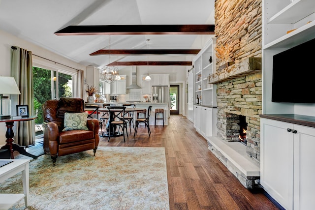 283 Wiley Rd, Douglas, MI 49406 - living area with wood finished floors, a stone fireplace, and a chandelier