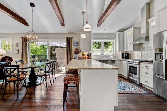 283 Wiley Rd, Douglas, MI 49406 - kitchen featuring stainless steel appliances, dark wood finished floors, beamed ceiling, decorative backsplash, and a breakfast bar