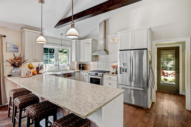 283 Wiley Rd, Douglas, MI 49406 - kitchen featuring stainless steel appliances, a sink, wall chimney range hood, a peninsula, and backsplash