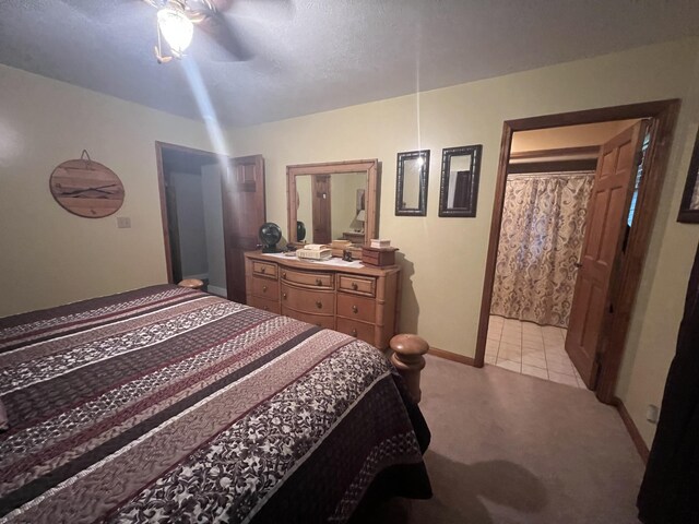 12050 S Ponderosa, Sand Lake, MI 49343 - bedroom featuring light carpet, baseboards, a ceiling fan, and ensuite bathroom