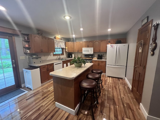 12050 S Ponderosa, Sand Lake, MI 49343 - kitchen featuring white appliances, light countertops, wood finished floors, recessed lighting, and open shelves