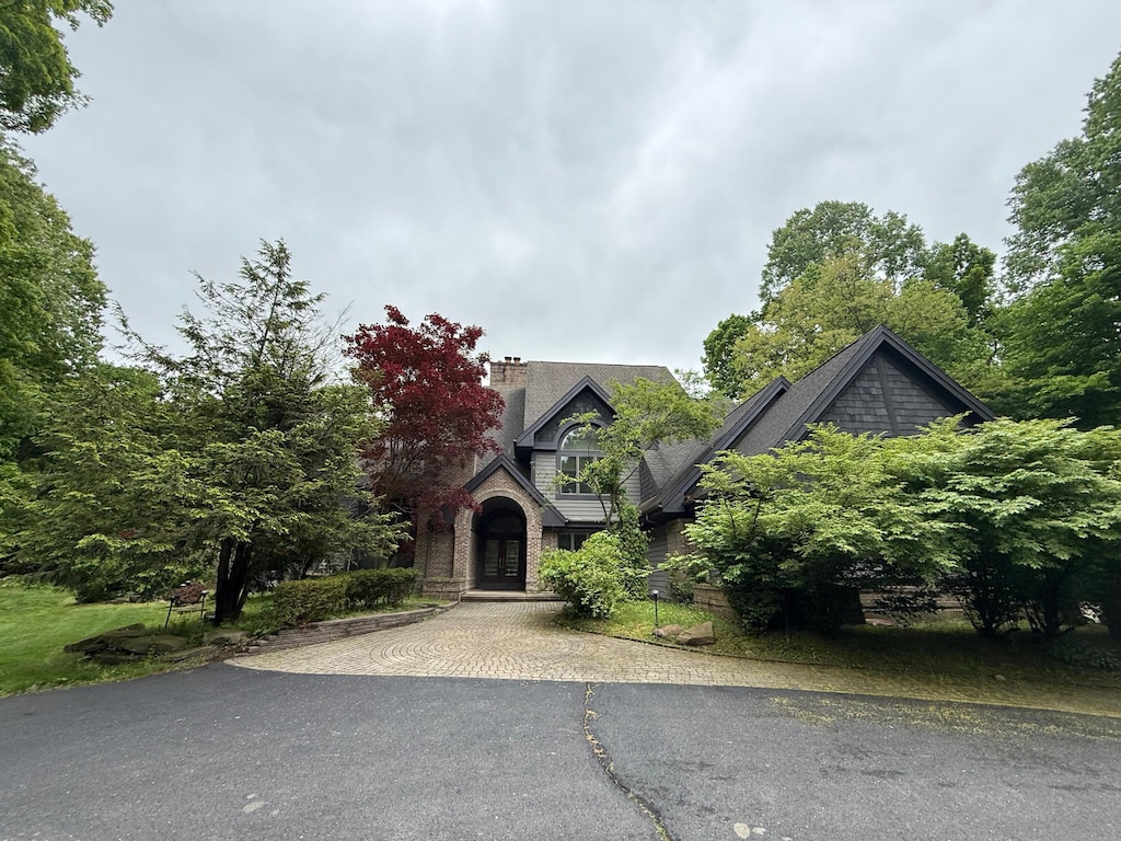 8180 N Ridge Rd, Canton, MI 48187 - view of front facade featuring french doors, asphalt driveway, and a chimney