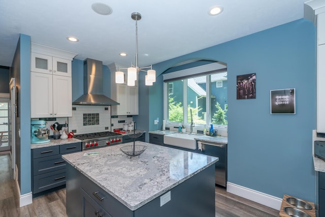 10543 Lakeshore Dr, West Olive, MI 49460 - kitchen with wall chimney range hood, stainless steel dishwasher, dark wood-style flooring, a sink, and a center island