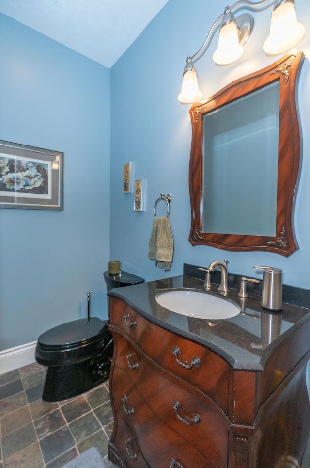 10543 Lakeshore Dr, West Olive, MI 49460 - half bathroom with vanity, toilet, and baseboards