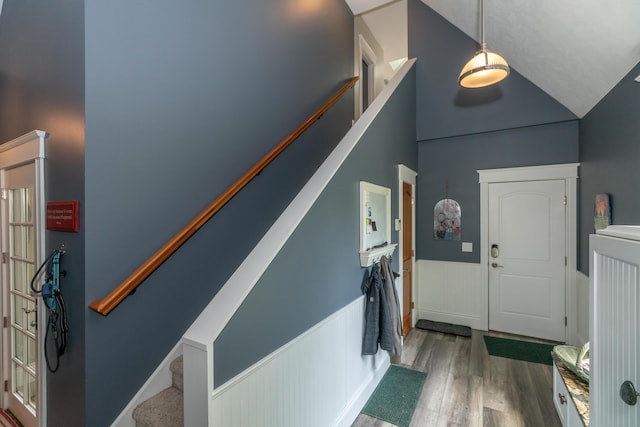 10543 Lakeshore Dr, West Olive, MI 49460 - entryway with wood finished floors, wainscoting, high vaulted ceiling, and stairs