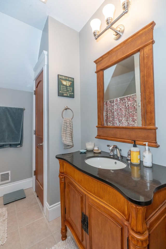 10543 Lakeshore Dr, West Olive, MI 49460 - full bath with vanity, tile patterned floors, and baseboards