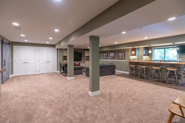 10543 Lakeshore Dr, West Olive, MI 49460 - basement featuring wet bar, a barn door, carpet, recessed lighting, and baseboards