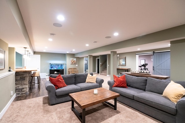 10543 Lakeshore Dr, West Olive, MI 49460 - carpeted living area with a barn door, recessed lighting, baseboards, and wood finished floors