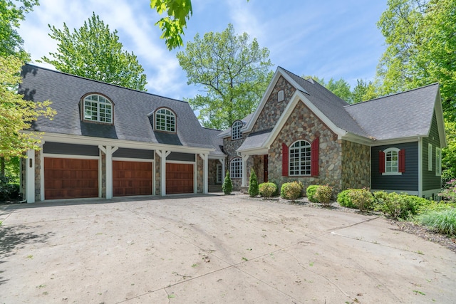 10543 Lakeshore Dr, West Olive, MI 49460 - view of front of house featuring stone siding, concrete driveway, and roof with shingles
