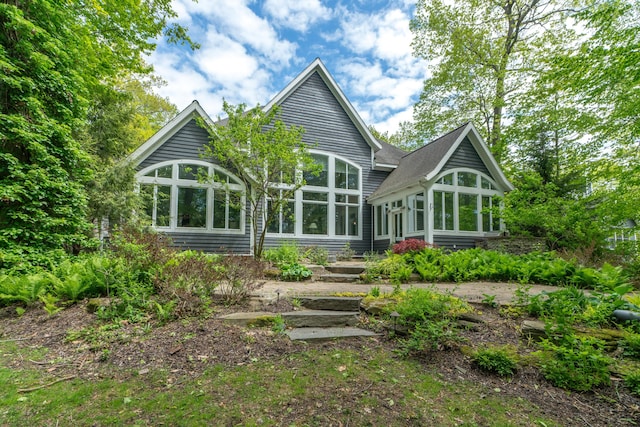 10543 Lakeshore Dr, West Olive, MI 49460 - rear view of house with a sunroom and a shingled roof